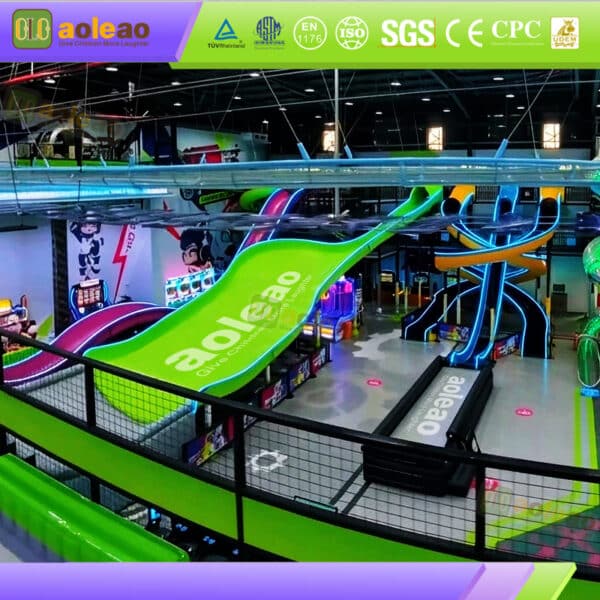 Commercial indoor slide equipment with a giant green slide and LED-lit curved slides in a family entertainment center