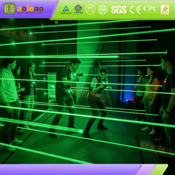 Close-up of a wall-mounted green laser beam emitter featured in an indoor laser maze game setup
